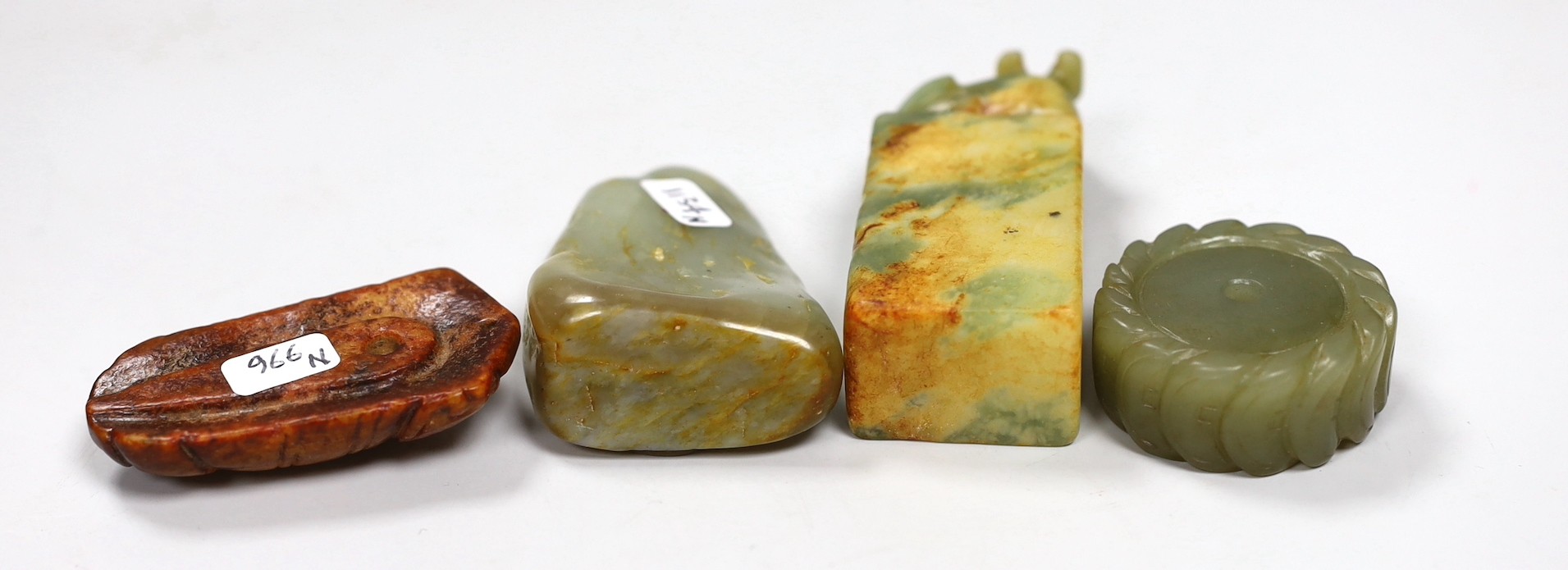 A Chinese green jade 'cash' wheel and a russet jade cicada, a jade pebble carving and a hardstone seal